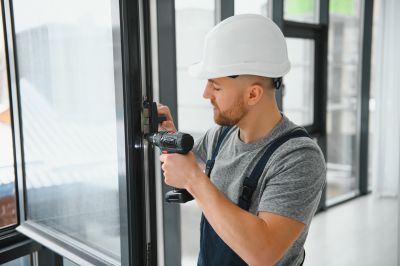 Handyman fixing a window